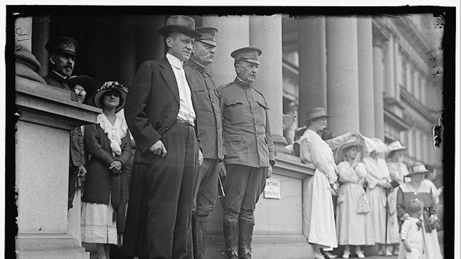 AU STEPS UP â€” Secretary of War Newton D. Baker, center left, and General Tasker H. Bliss, center, greet incoming students at a convocation ceremony.