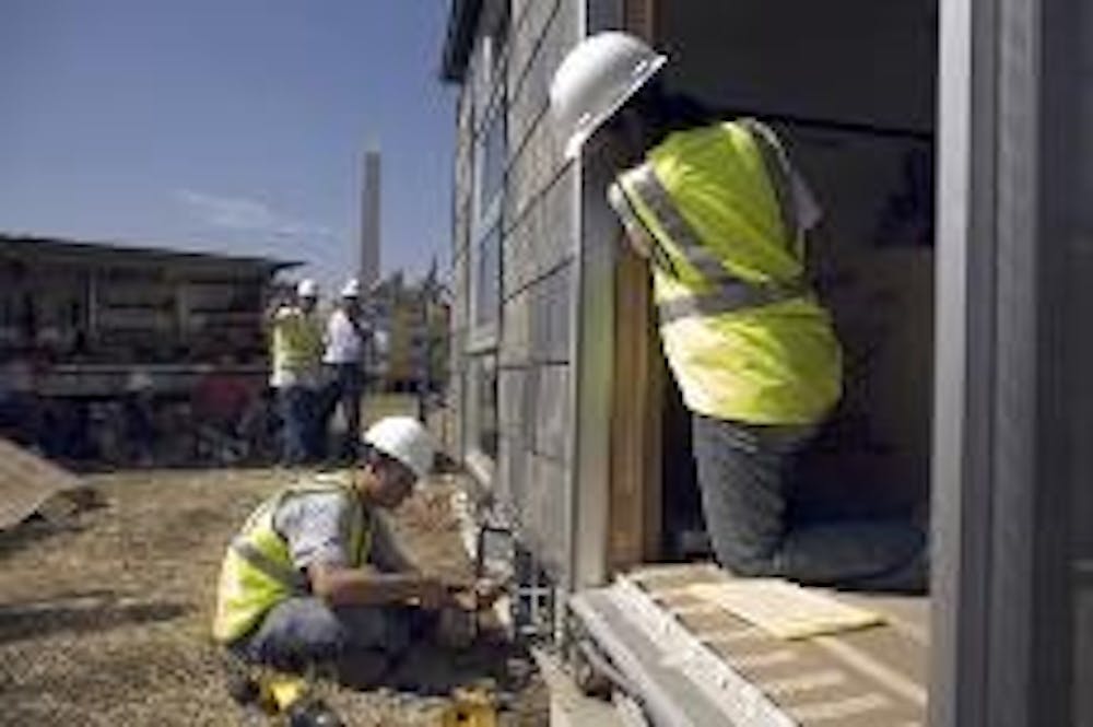 ENERGY EFFICIENT - Students from Penn State work on completing their house for the third annual Solar Decathlon on the National Mall Oct. 4. The entry, called MorningStar, is an 800-square-foot home powered by solar energy. The competition was held from O