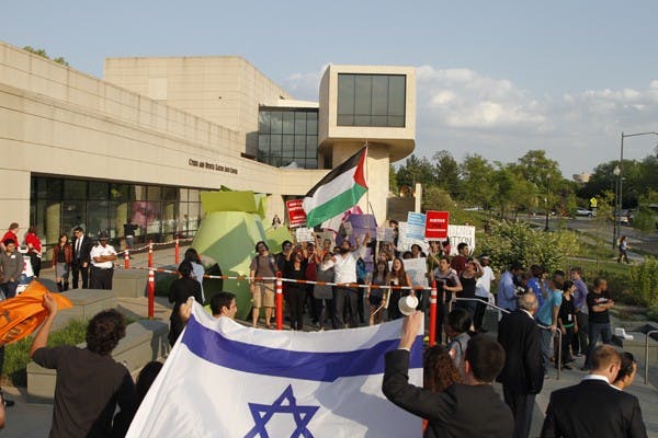 CLASH â€” AU students gather outside of Katzen Arts Center on Thursday afternoon to protest Israeli Ambassador to the United States Michael Orenâ€™s visit to AU. During Orenâ€™s speech, groups of students stood up and walked out. Oren ignored them at first but said â€œI wish you would stay and ask questions,â€ after the third group left. 