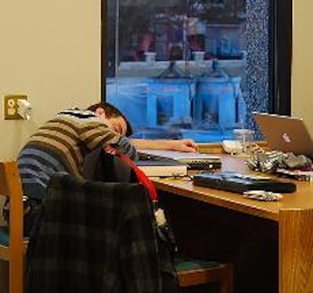 POWER NAP - A student catches some Zs in the Bender Library. While the D.C. Public Library recently banned sleeping in its buildings, AU library officials said they would not implement a similar policy.  AU's Outreach Librarian Mary Mintz said students na