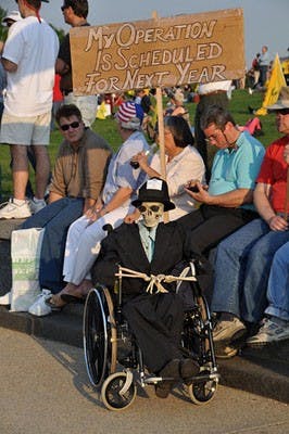 DEATH BY TAXES â€” Protestors take a few minutes to rest at the National Mall during Thursdayâ€™s Tax Day Tea Party rally. AU College Republicans were among the thousands of people gathered near the Washington Monument.