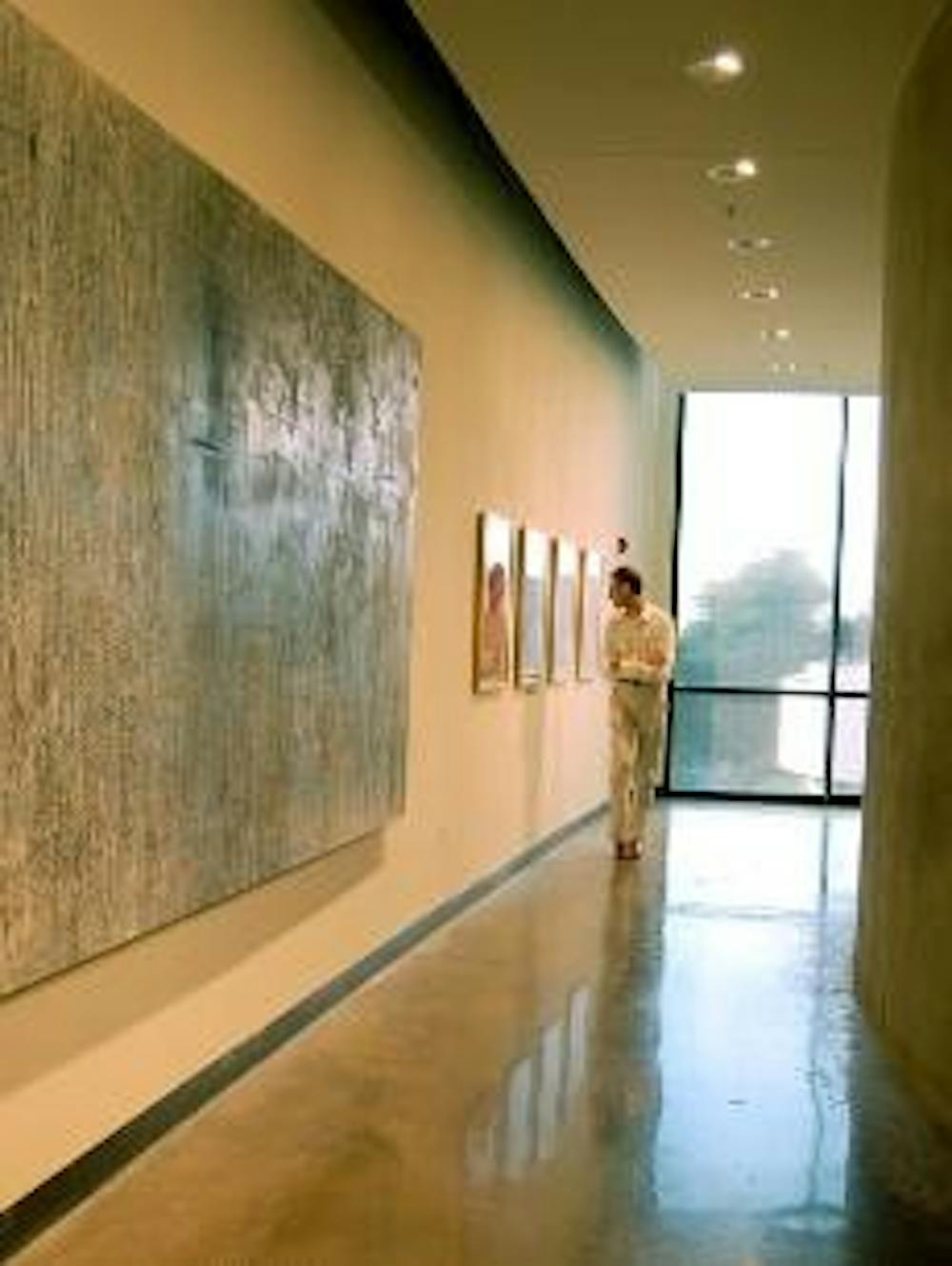 NEW ART - A visitor views the new exhibits at the Katzen Arts Center, including "All in the Family: A Juried Show of American University Alumni;" "Songs Without Words," an exhibit of photography by Sophia Tolstoy;  "Listening to Ivy;" and "Topophilia Imbu