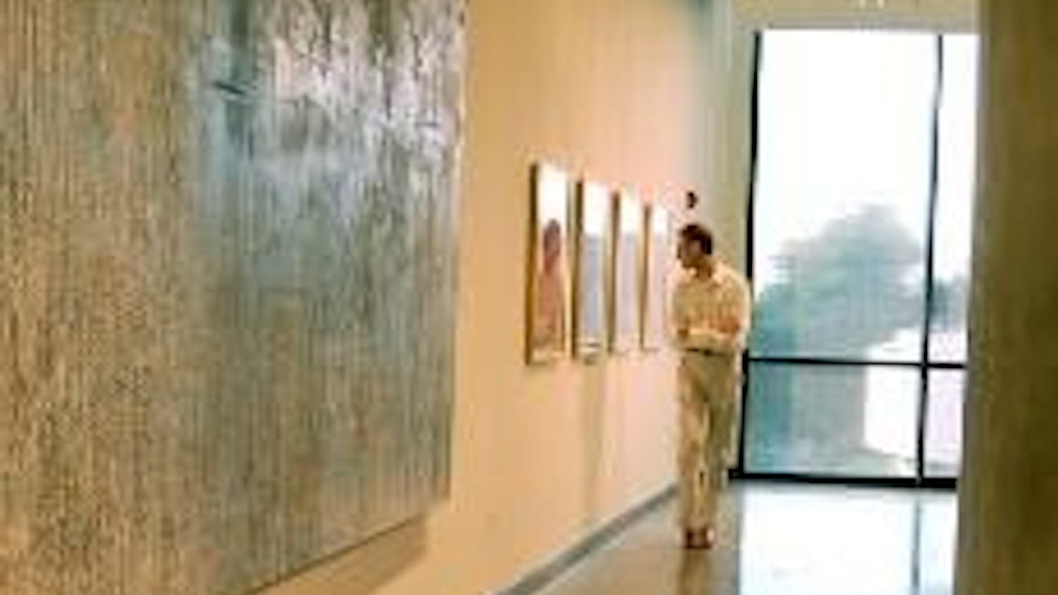 NEW ART - A visitor views the new exhibits at the Katzen Arts Center, including "All in the Family: A Juried Show of American University Alumni;" "Songs Without Words," an exhibit of photography by Sophia Tolstoy;  "Listening to Ivy;" and "Topophilia Imbu