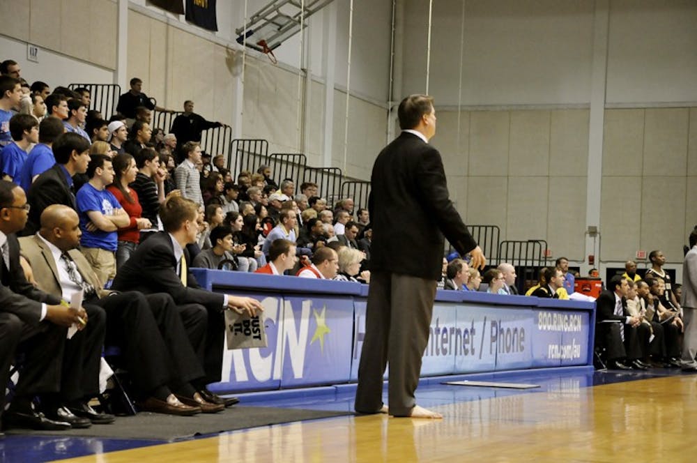 Menâ€™s basketball Head Coach Jeff Jones looks on during Wednesdayâ€™s game. Jones went barefoot while coach to bring attention to the charity, Samaritans Feet.