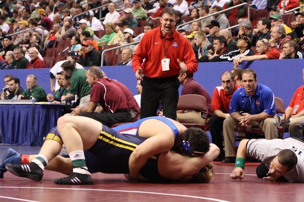Cheering him on â€” The Eaglesâ€™ head coach, Mark Cody, encourages one of his wrestlers during a bout. Cody was recently named the National Coach of the Year by the National Wrestling Coaches Association. He led the Eagles to a fifth place finish at this yearâ€™s national championships. 