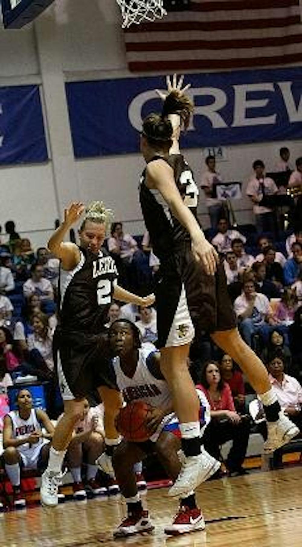 PUMP FAKE -Senior point guard, Pam Stanfield goes up for a shot against two Lehigh players in the Eagles' 65-56 victory over the Mountain Hawks.