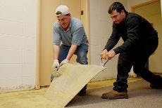 CLEANING UP- Workers tear up flooring on Letts North Terrace. The floor was flooded Saturday morning when a pipe burst. Residents will be housed in the Letts Sky Lounge and other lounges in Anderson and Centennial until the floor is cleaned up, likely for