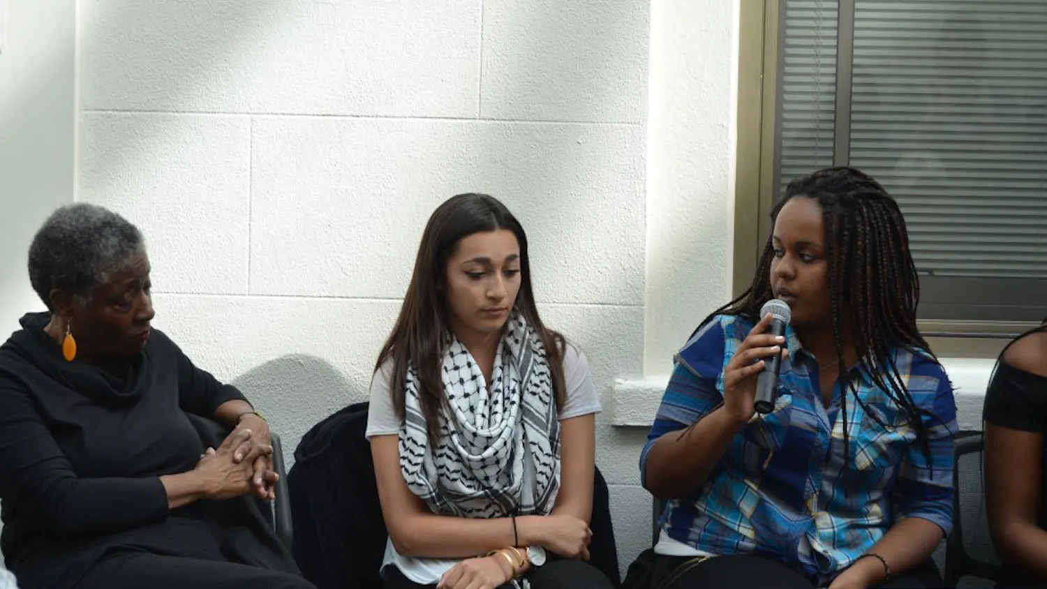 Student activist Helen Abraha, right, speaks during a panel at "Black Lives Matter: A Conversation." 