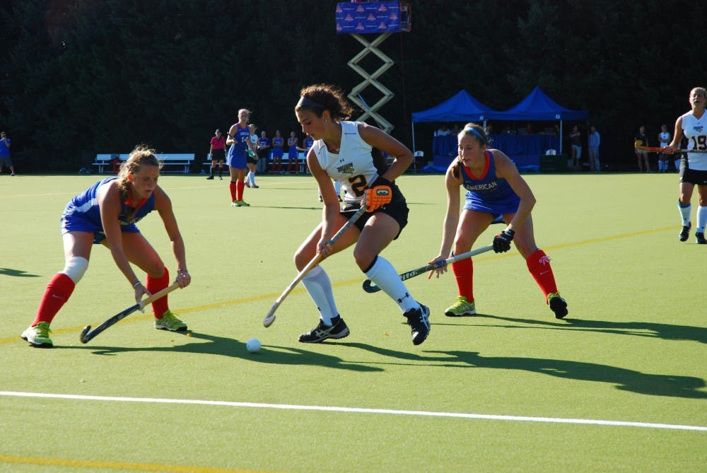 	Two AU field hockey team players corner a Towson player on a Oct. 18 game.