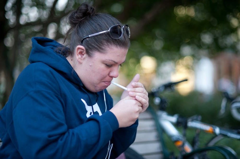 Sarah Wisniewski, a first year graduate student in the School of Public Affairs, takes a smoke break on campus. President Neil Kerwin announced Nov. 5 in a University-wide memo that AU would go smoke- and tobacco-free by Aug. 1, 2013.