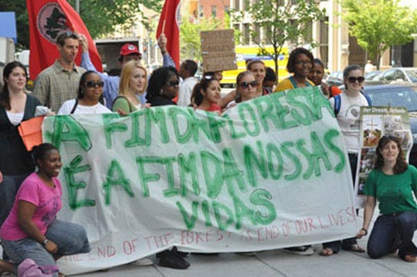 A CROSS TO BEAR â€” Activists pose for a picture during Fridayâ€™s rally outside the Brazilian Consulate to honor Sister Dorothy Stang who was murdered for defending farmersâ€™ land rights.