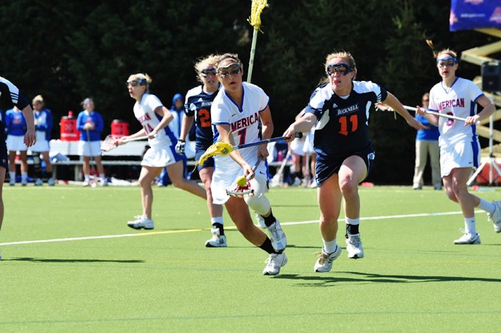 fighting for possession â€” Sophomore attacker Kimberly Collins tries to get past a Bucknell University player during AUâ€™s 20-11 victory. Collins gave the team two assists and contributed one goal.