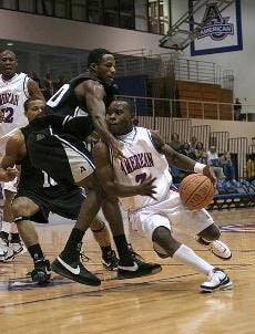 DRIVING HARD - Junior point guard Derrick Mercer lowers his shoulder and takes on his defender on his way to score a basket. Mercer scored 11 points, but it was not enough to prevent the Eagles from falling 83-68.