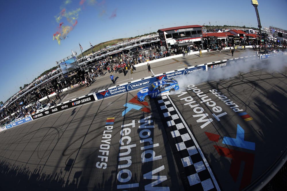 MADISON, ILLINOIS - SEPTEMBER 07: Denny Hamlin, driver of the #11 Progressive Toyota, celebrates with a burnout after winning the NASCAR Cup Series Enjoy Illinois 300 at WWT Raceway on September 07, 2025 in Madison, Illinois. (Photo by Sean Gardner/Getty Images)