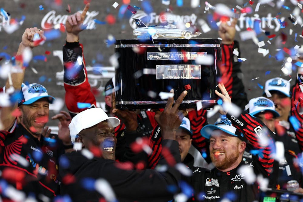 DAYTONA BEACH, FLORIDA - FEBRUARY 15: Tyler Reddick, driver of the #45 Chumba Casino Toyota, and Michael Jordan, NBA Hall of Famer and co-owner of 23XI Racing lift the Harley J. Earl Trophy in victory lane after winning the NASCAR Cup Series Daytona 500 at Daytona International Speedway on February 15, 2026 in Daytona Beach, Florida. (Photo by Chris Graythen/Getty Images)