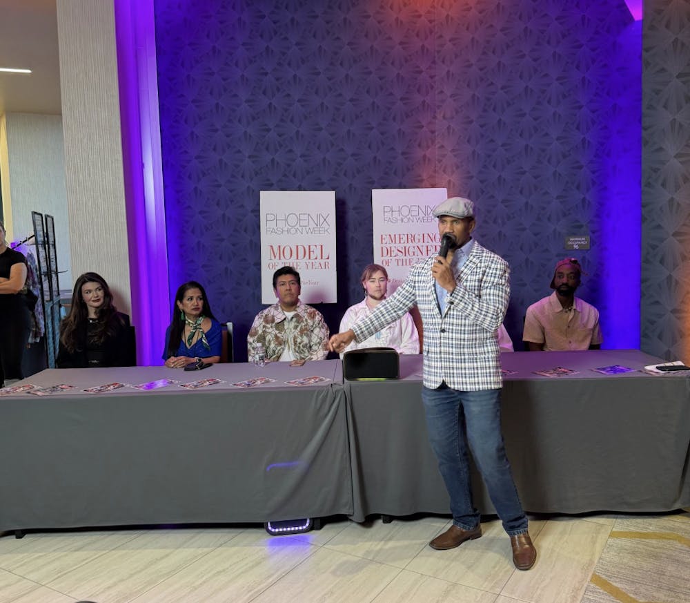 Executive Director of Phoenix Fashion Week Brian Hill, speaking in front of the panel of designers.
