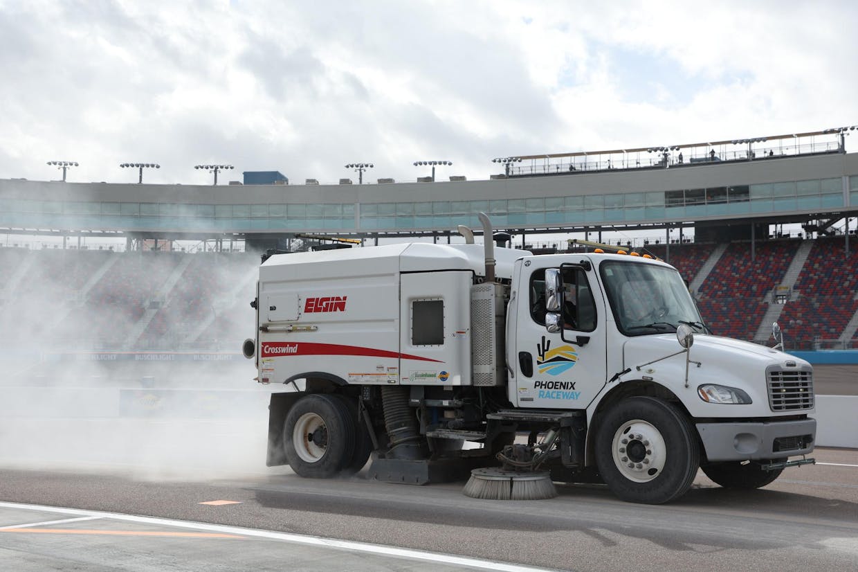 A Phoenix Raceway sweeper truck working to dry pitlane during session three of the Unser INDYCAR Open Test. (Photo by Matt Fraver).jpg