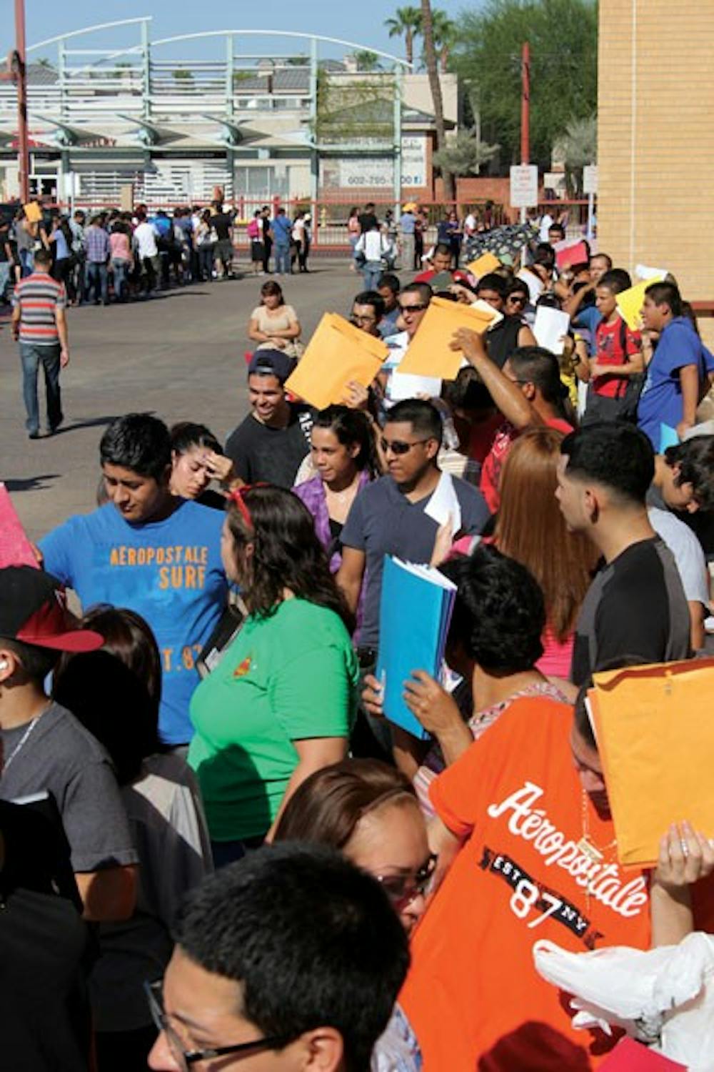 Three thousand DREAMers and supporters lined up for a Deferred Action Application Clinic-Workshop at Central High School Saturday morning. DREAMers are a group of undocumented immigrants who were recently denied public benefits such as scholarships. (Photo by Ana Ramirez)