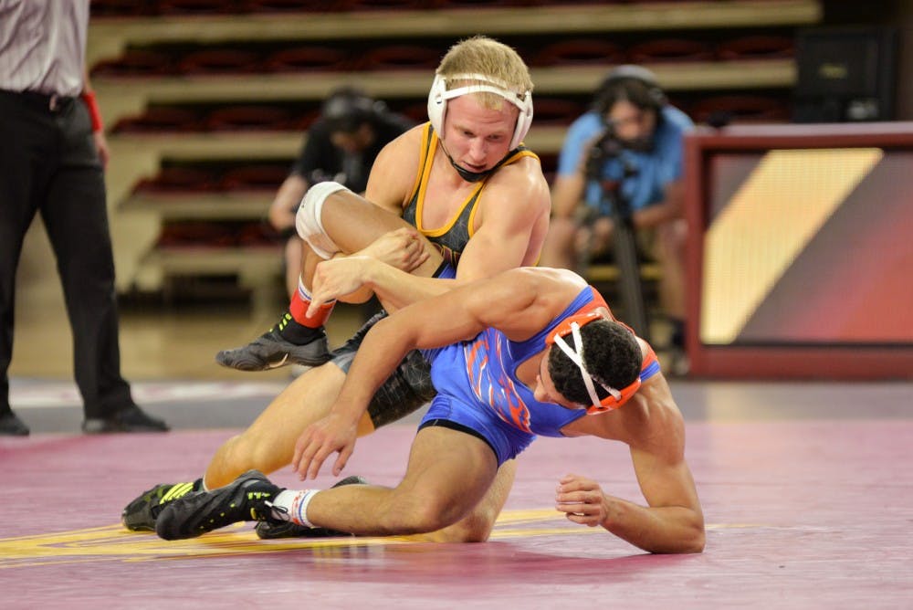 Sun Devil senior Matt Kraus and Geordan Martinez from Boise State take it to the mat during the final match between on Sunday, November 21, 2015, at the Wells Fargo Arena in Tempe.