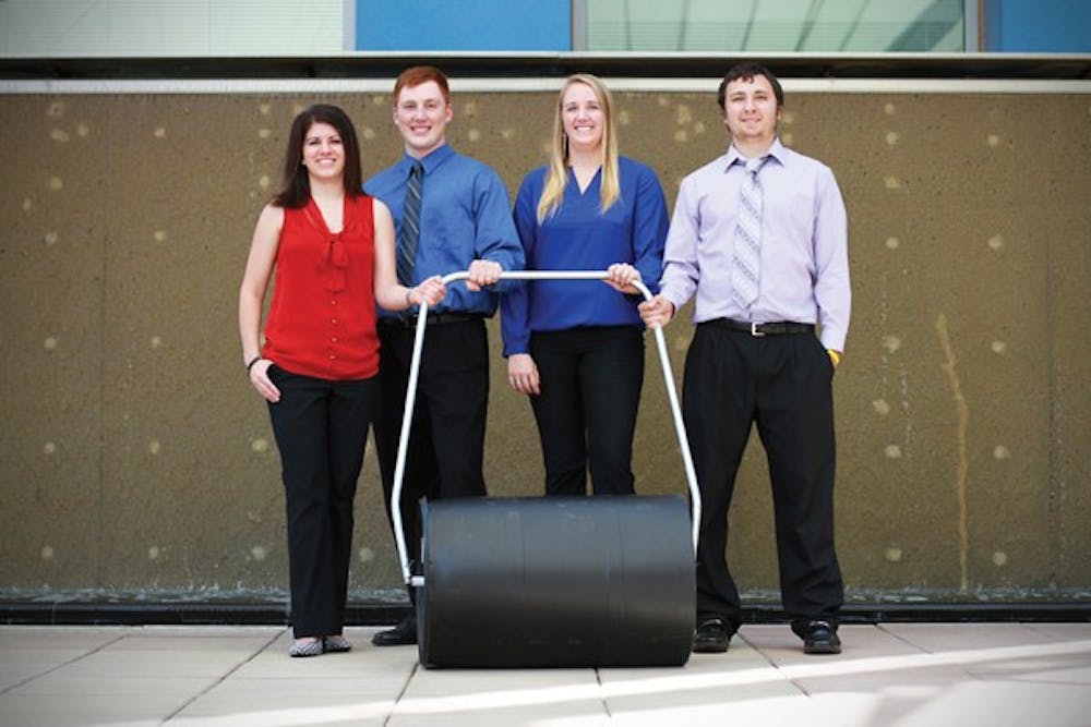 Lindsay Fleming, Jared Schoepf, Taylor Barker and Jacob Arredondo stand with their SafeSIPP unit outside of Skysong on Sept. 28.  SafeSIPP is a water filtering system that allows users in underdeveloped countries transport water easier while purifying it simultaneously. (Photo by Sam Rosenbaum)
