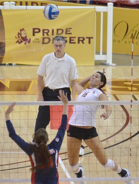 HANG TIME: ASU sophomore outside hitter Danica Mendivil (right) leaps to spike the ball over a UA defender in last year’s Oct. 29 meeting against the Wildcats. The volleyball team will begin their season by hosting the Sheraton Classic this weekend. (Photo by Aaron Lavinsky)