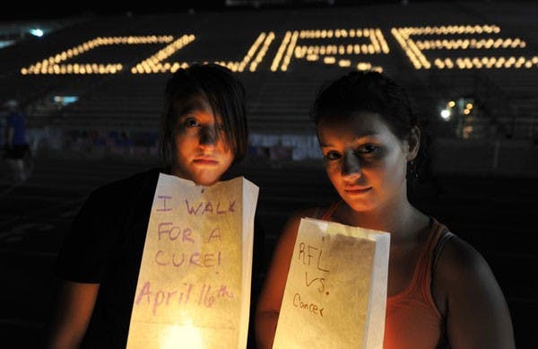 12 HOUR NIGHT WALK: ASU students Hayley Magerman and Emily O'Malley hold candlelit bags with handwritten messages in support of the fight against breast cancer during ASU's Relay for Life on Friday night. (Photo Courtesy of Mihcael Arellano)