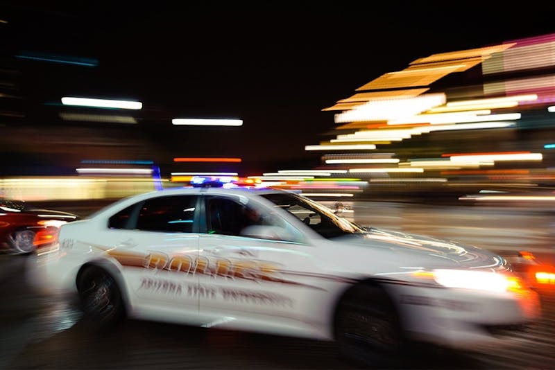 An ASU police cruiser turns from Mill Avenue onto Fifth Street in Tempe, Arizona, on Sunday, Oct.19, 2014.
