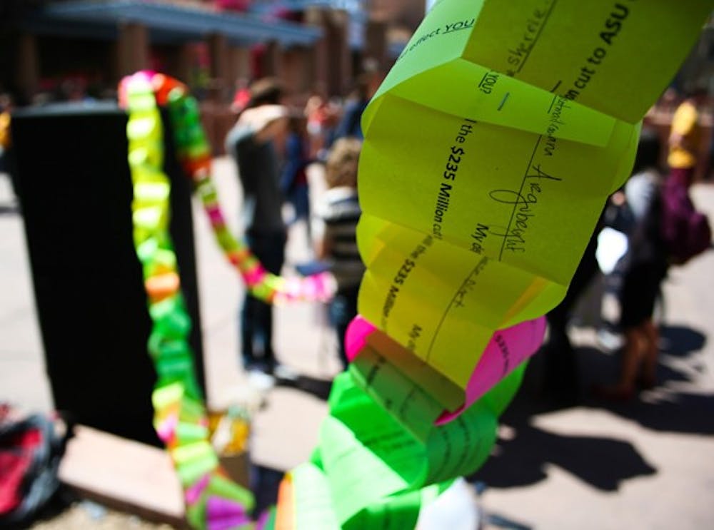 MONEY CHAIN: Students on the Tempe campus added up the total cost of their college education and formed a paper chain to protest the proposed $235 million budget cuts to state universities. (Photo by Lisa Bartoli)