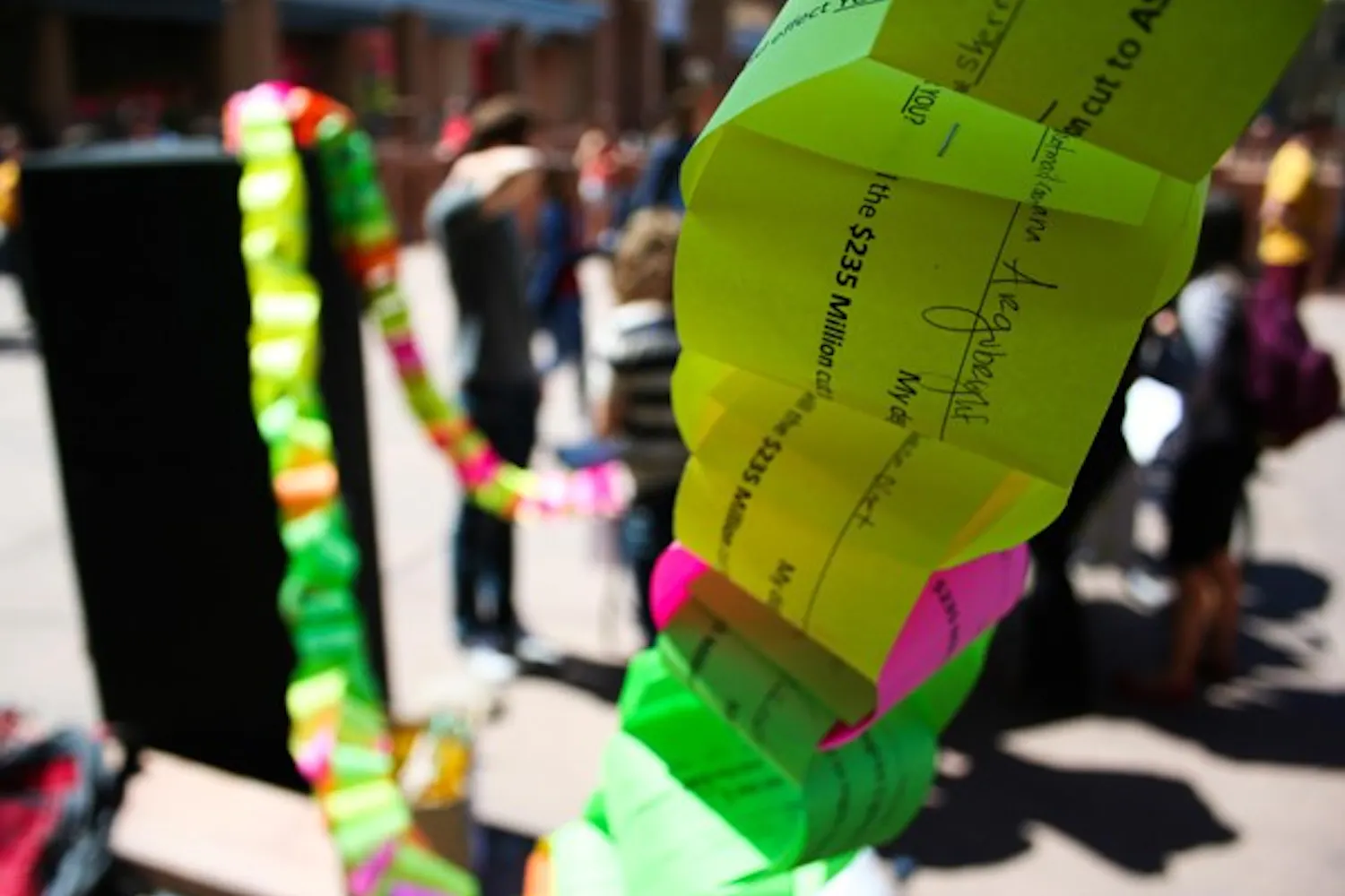 MONEY CHAIN: Students on the Tempe campus added up the total cost of their college education and formed a paper chain to protest the proposed $235 million budget cuts to state universities. (Photo by Lisa Bartoli)