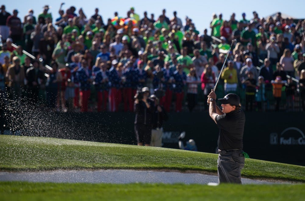 Phil Mickelson hits the ball out of a sand trap at the 16th hole of the Waste Management Phoenix Open on Saturday, Feb. 6, 2016, at TPC Scottsdale.