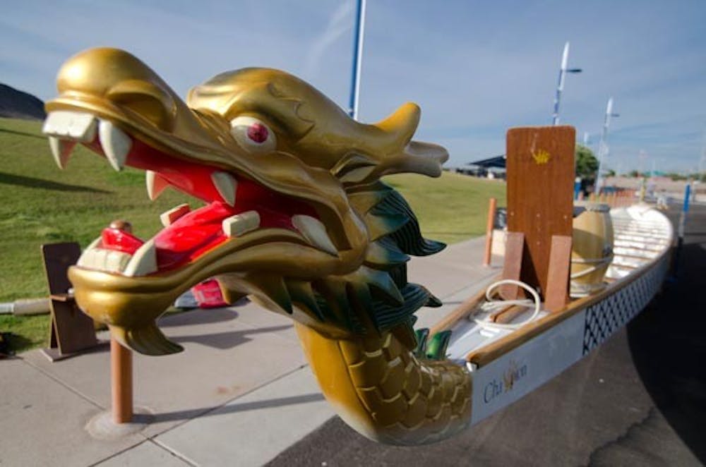 GOLDEN DRAGON: The dragon boat community gathered Saturday at Tempe Town Lake to educate others and recruit new members. People were allowed to get onboard a dragon boat and try paddling it. (Photo by Aaron Lavinsky)