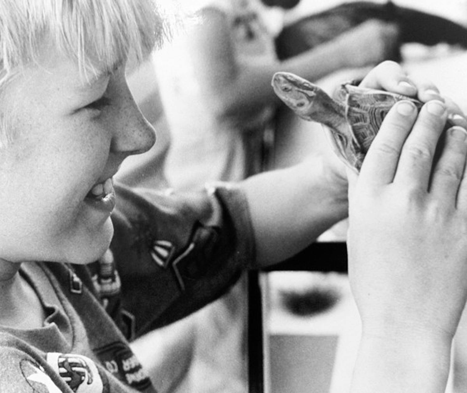 NEW FRIENDS: David Borshein, 8, from Mesa learns about wildlife at ASU in 1988. (Photo by Irwin Daugherty)