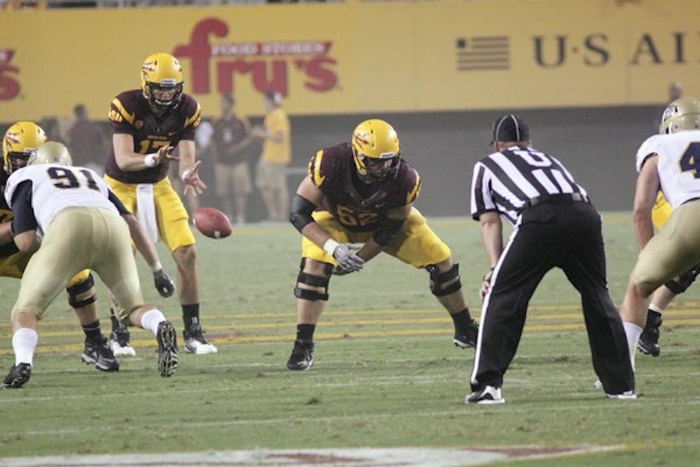 TOUGH OUTLOOK: ASU senior center Garth Gerhart snaps the ball to junior quarterback Brock Osweiler during the UC Davis game earlier this season. The Sun Devils face an uphill battle against USC on Saturday. (Photo by Beth Easterbrook)