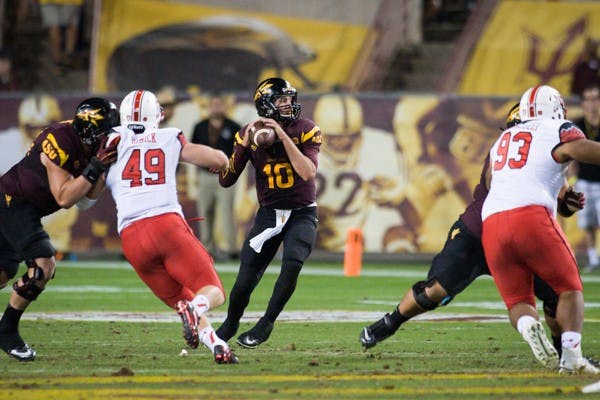 Redshirt senior quarterback Taylor Kelly looks for a receiver during the 2nd half of the game against Utah on Nov 1. ASU defeated Utah in overtime 19-16. (Photo by Andrew Ybanez)