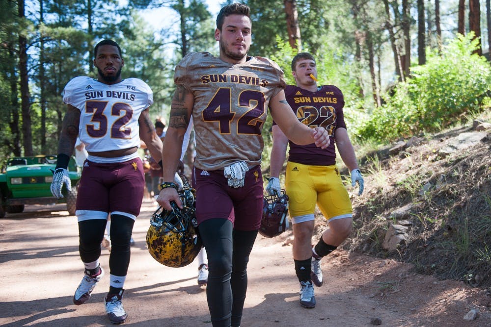 Redshirt senior linebacker Antonio Longino (left), redshirt senior safety Jordan Simone and sophomore fullback Mark Cosgrove walk to the practice field during the last day of Camp Tontozona on Saturday, Aug. 15, 2015, in Payson, Arizona.