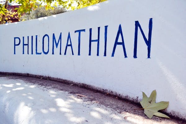Sunshine sneaks through the tree branches and speckles the Philomathian Bench, which is in front of Old Main on the Tempe campus. (Photo by Mackenzie McCreary)