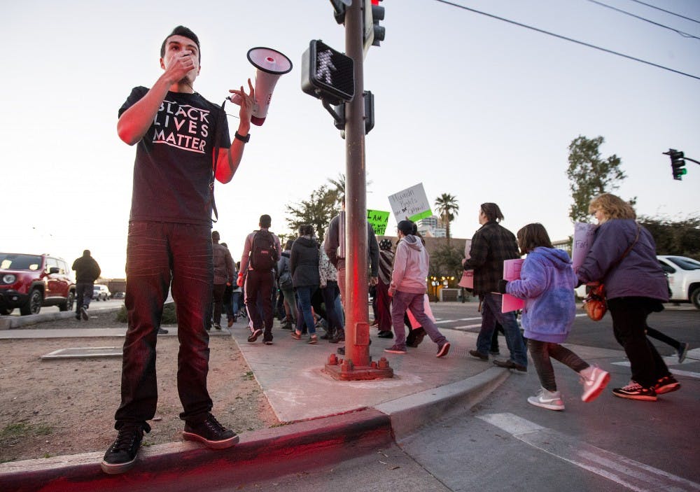 Randy Perez, a justice studies, public policy and political science junior, leads a chant during a protest in support of Muslim, refugee and immigrant rights at the Old Main building on the Tempe campus on Thursday, Jan. 26, 2017. 
