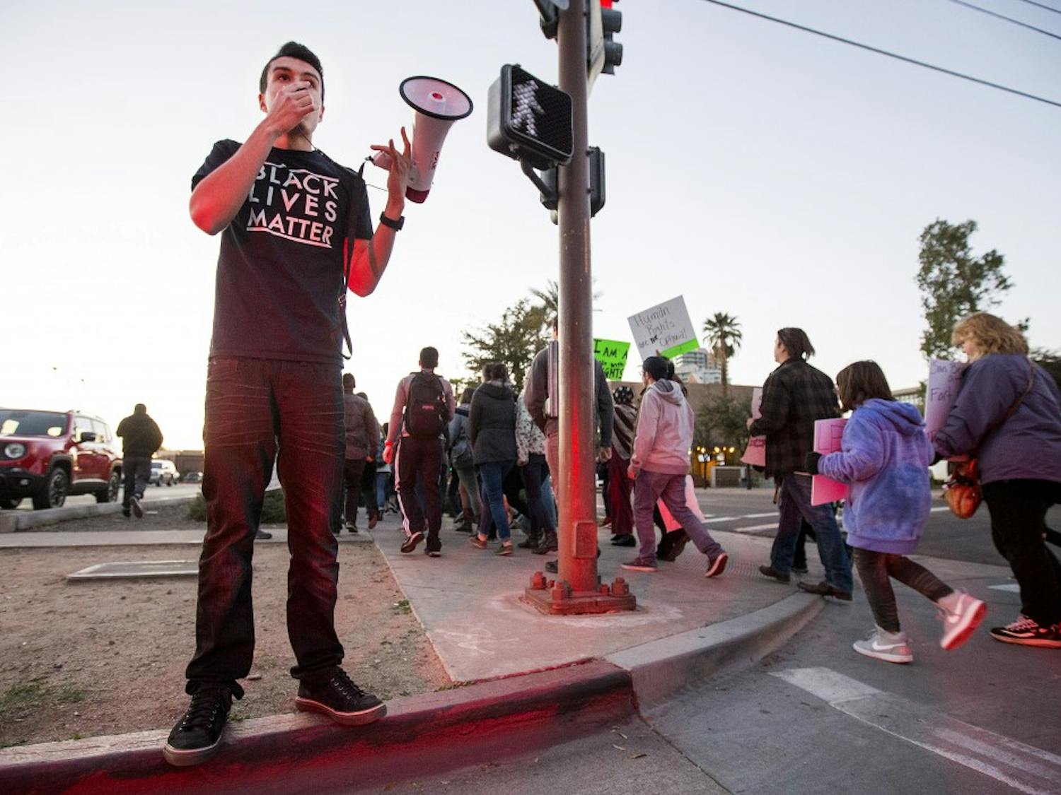 Randy Perez, a justice studies, public policy and political science junior, leads a chant during a protest in support of Muslim, refugee and immigrant rights at the Old Main building on the Tempe campus on Thursday, Jan. 26, 2017. 