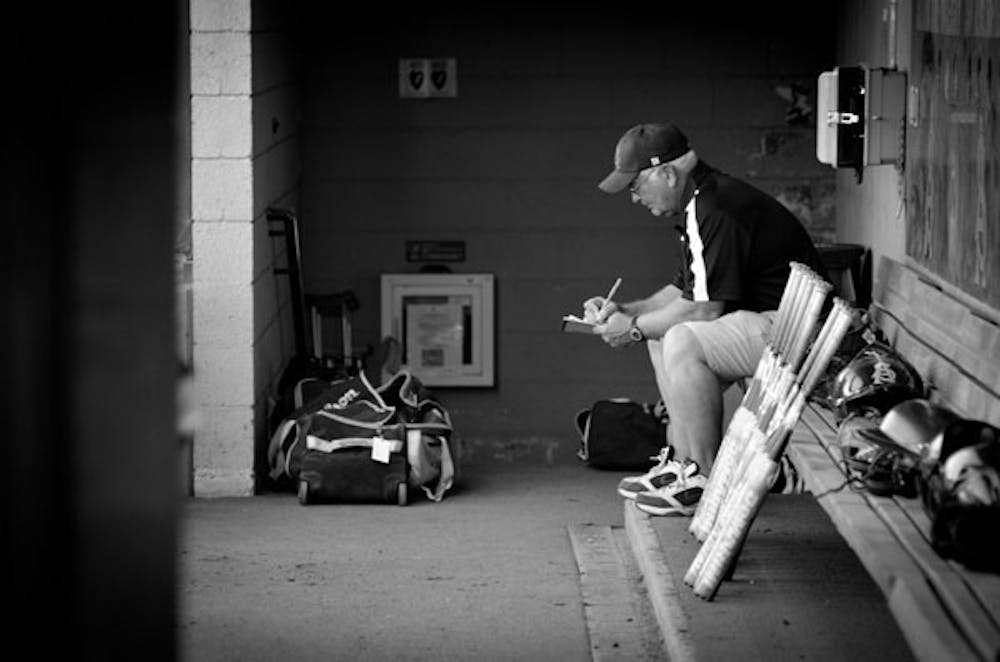 ASU Softball Coach Clint Myers goes over some game notes on April 10 against McNeese. The team fell short in this year's College World Series. (Photo by Aaron Lavinsky)