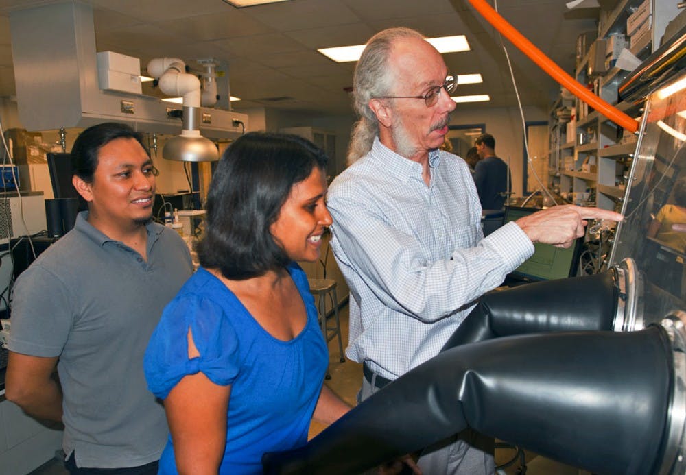 ASU researchers Dan Buttry (right) and coworkers Helme Castro (left) and Poonam Singh work in the lab.
(Photo Courtesy of ASU News/Photo by Mary Zhu)