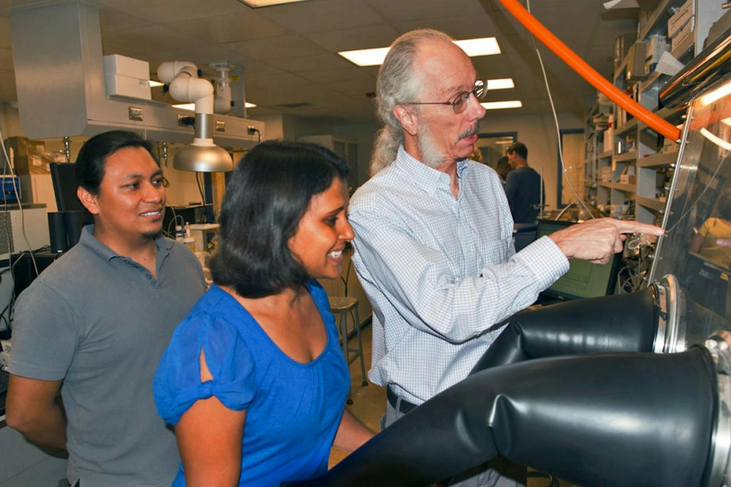 ASU researchers Dan Buttry (right) and coworkers Helme Castro (left) and Poonam Singh work in the lab.
(Photo Courtesy of ASU News/Photo by Mary Zhu)