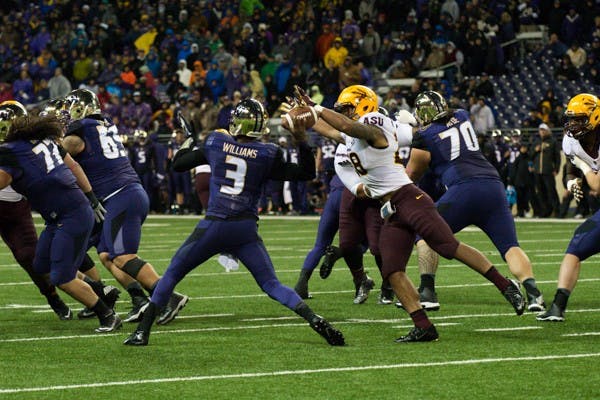Redshirt sophomore linebacker Viliami (Laiu) Moeakiola strips the ball from Washington quarterback Troy Williams during the game against Washington on Oct. 25. ASU defeated Washington 24-10. (Photo by Andrew Ybanez)