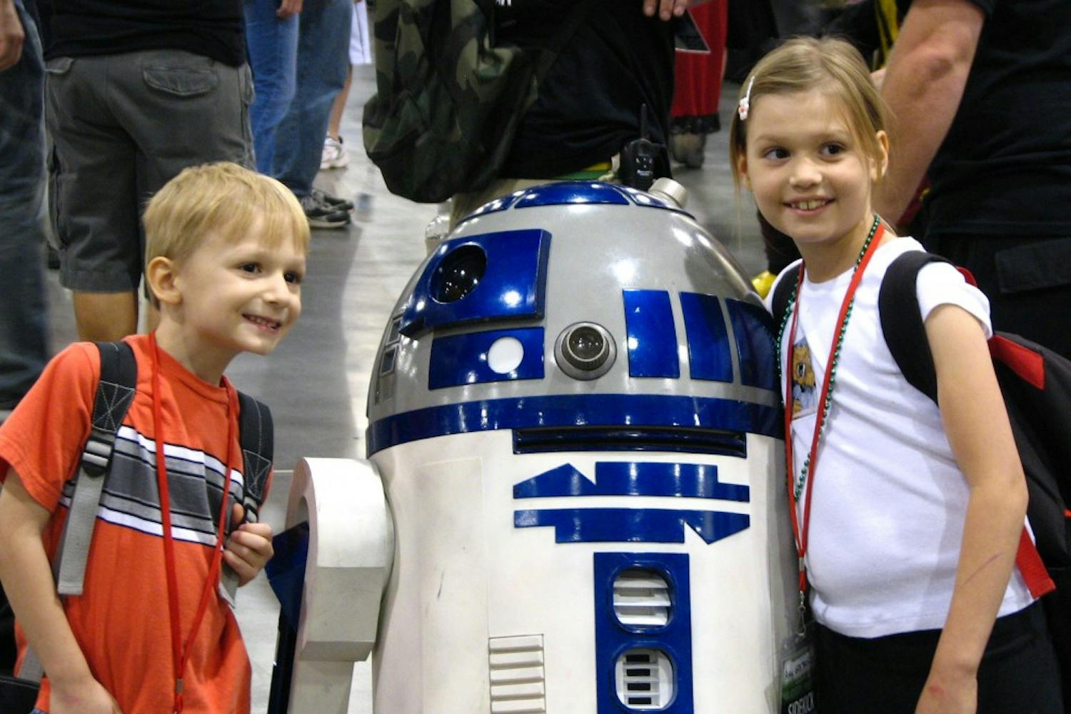 GEEK PARADISE: Children pose next to a replica of R2D2 at the Phoenix Comi-Con on Thursday night. Thousands of comic and sci-fi fans are expected to attend the annual convention this year that will include exhibits, appearances by film and television stars and hundreds of vendors. (Photo by Travis McKnight)