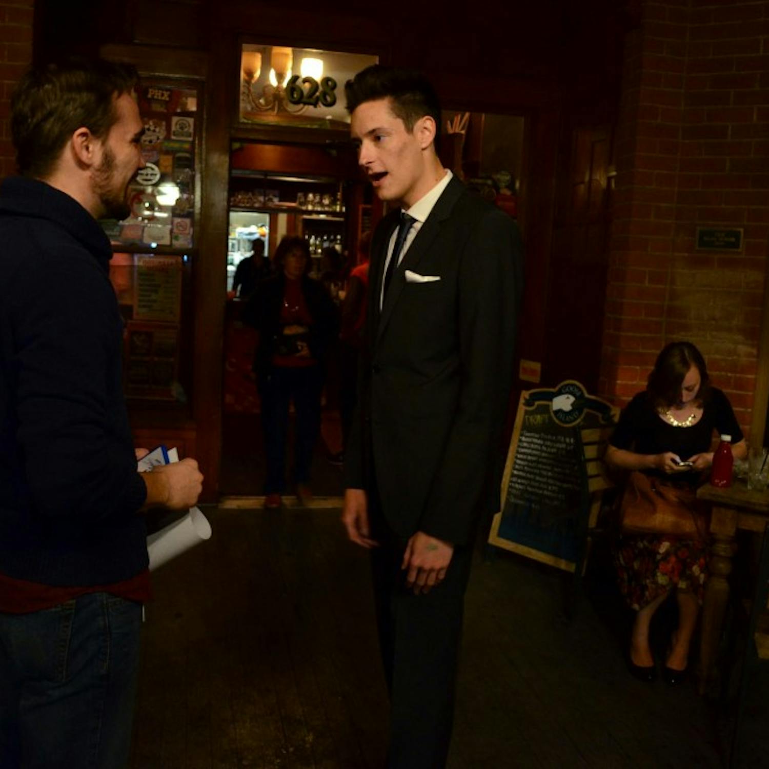 Producer Ryan Casey chats with actor and friend David Mayorga at the At Dusk after-party at The Rose and Crown Pub Nov. 20. Photo by Heather Hudzinski. 