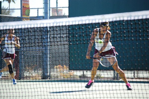 Senior Jacqueline Cako dips her racquet low to pick a scoop shot, as her doubles partner senior Nicole Smith backs her up against UC Davis on Jan. 20. The team will rely on Cako when they face Oklahoma this weekend. (Photo by Murphy Bannerman)