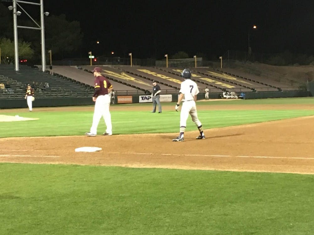 Meiji University outfielder Hitoshi Kase leads off first&nbsp;with Christopher Beall playing defense&nbsp;during the&nbsp;exhibition game at Phoenix Municipal Stadium&nbsp;on Tuesday, March 15, 2016.&nbsp;&nbsp;ASU baseball won 4-3.