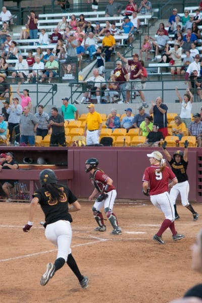 #33 Outfielder Senior Alix Johnson makes a break for home as #11 Shortstop Freshman Chelsea Gonzalez cheers her on. Johnson and Gonzalez were the first of 5 runs in the comeback 7th inning that led to a 7-5 victory over Stanford Mar. 24. (Photo by Andrew Ybanez)