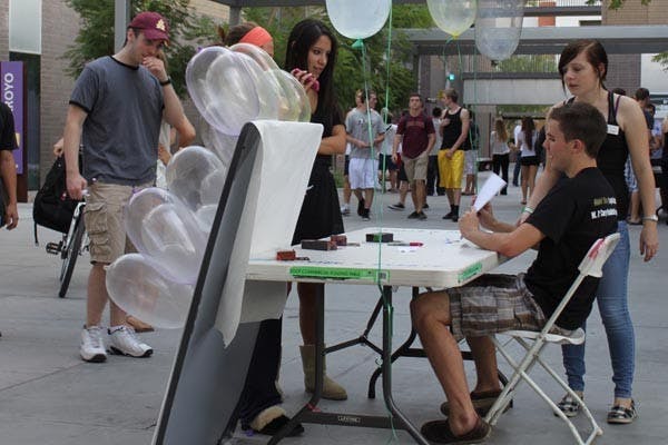 PALOOZA: Students at the Hassayampa Academic Village participate in a Safe-Sex-Palooza outside the dorms. Students received free condoms and popcorn while learning about the dangers of sexually transmitted infections. (Photo by Rosie Gochnour)