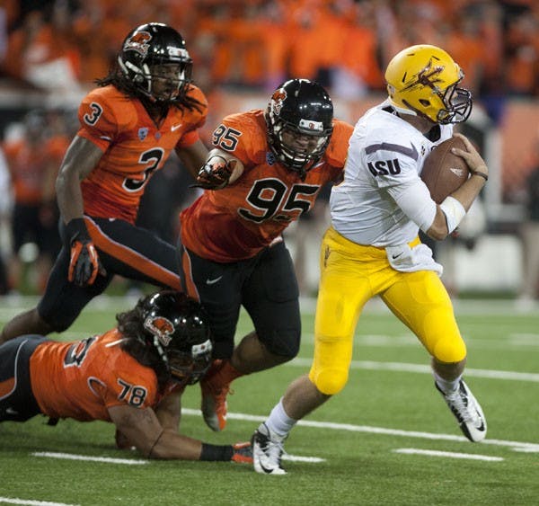Redshirt sophomore quarterback Taylor Kelly gets pressured by Oregon State defensive end Scott Crichton during the Sun Devils’ 36-26 loss to the Beavers last Saturday. (Photo courtesy of Neil Abrew/The Daily Barometer)