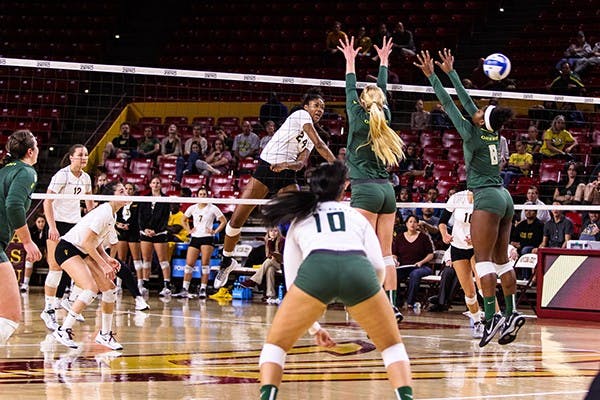 Junior middle blocker Mercedes Binns powers a shot in the fourth set of the ASU vs Oregon volleyball game at the Wells Fargo Arena on November 11th, 2014. The Sun Devils would win the fourth set 26-24 but lose in five 3-2 to the Ducks. (Photo by Daniel Kwon)